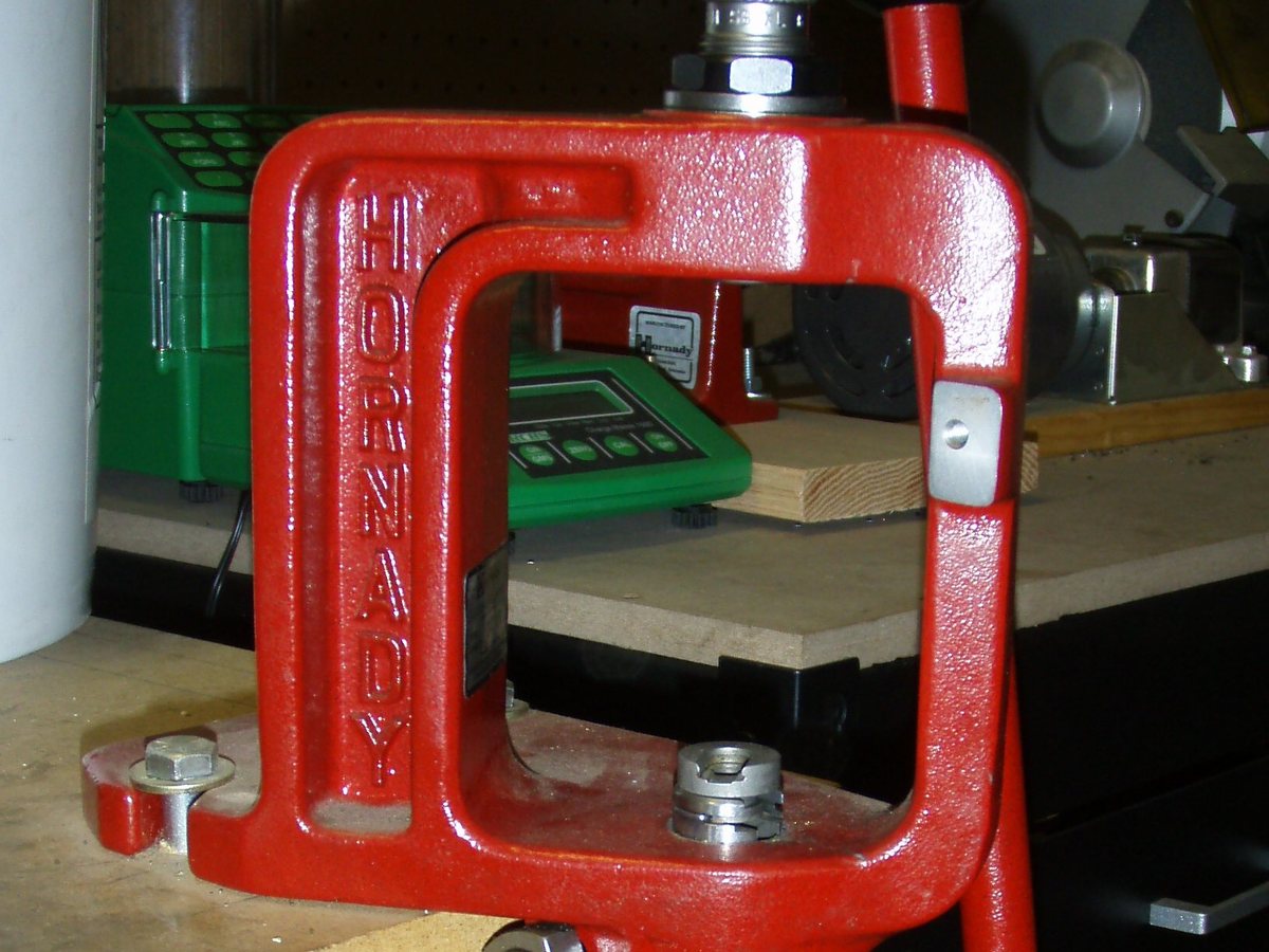 A cast turret bolted to a bench, a scale already zeroed. Powder stays a counter.