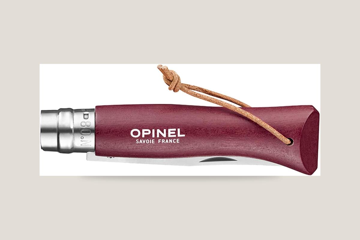 Opinel Colorama No. 08 folding knife with a burgundy painted handle and leather lanyard.