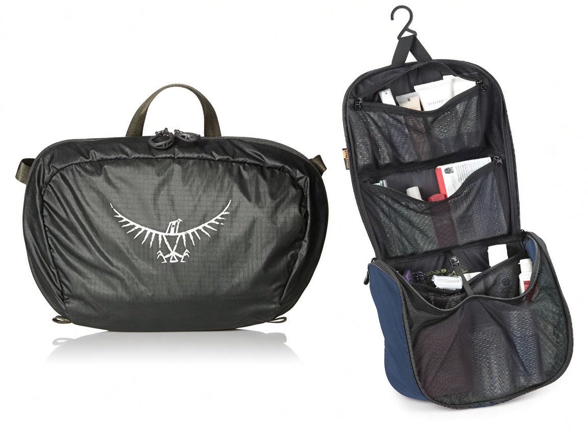 A closed grey Osprey toiletry pouch beside an open navy hanging toiletry bag