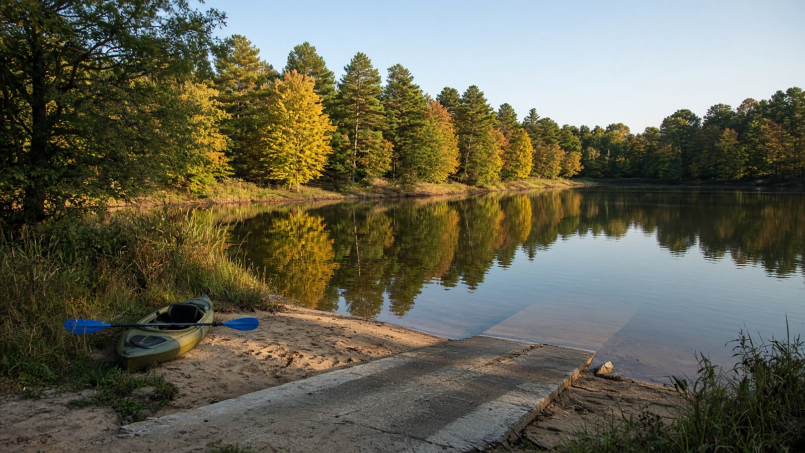 A quiet September lake with a kayak on an empty ramp after the ski crowd left