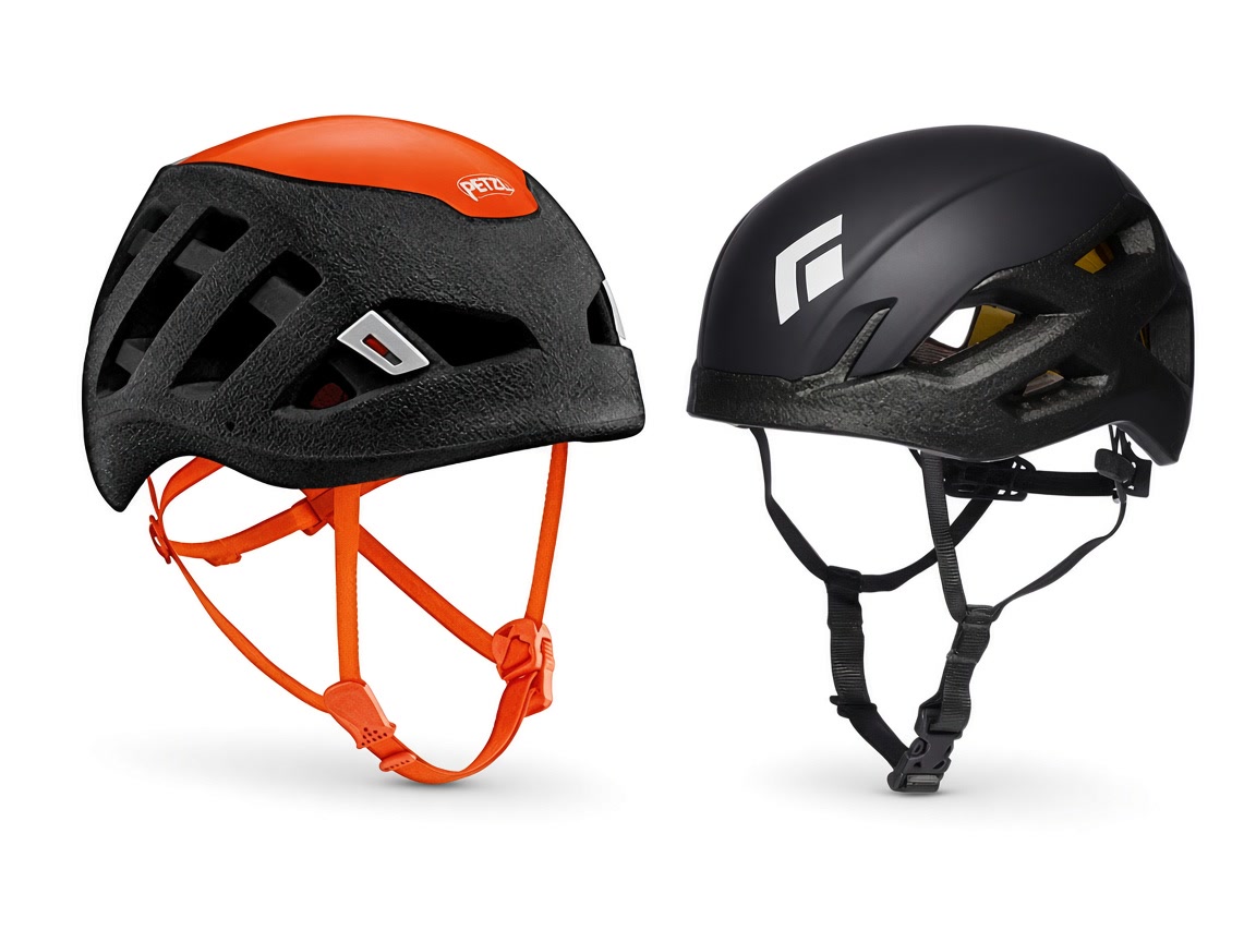 An orange and black Petzl climbing helmet beside a black Black Diamond climbing helmet