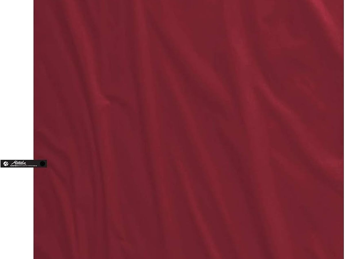 Matador NanoDry packable shower towel, Large, rust, with its silicone case.