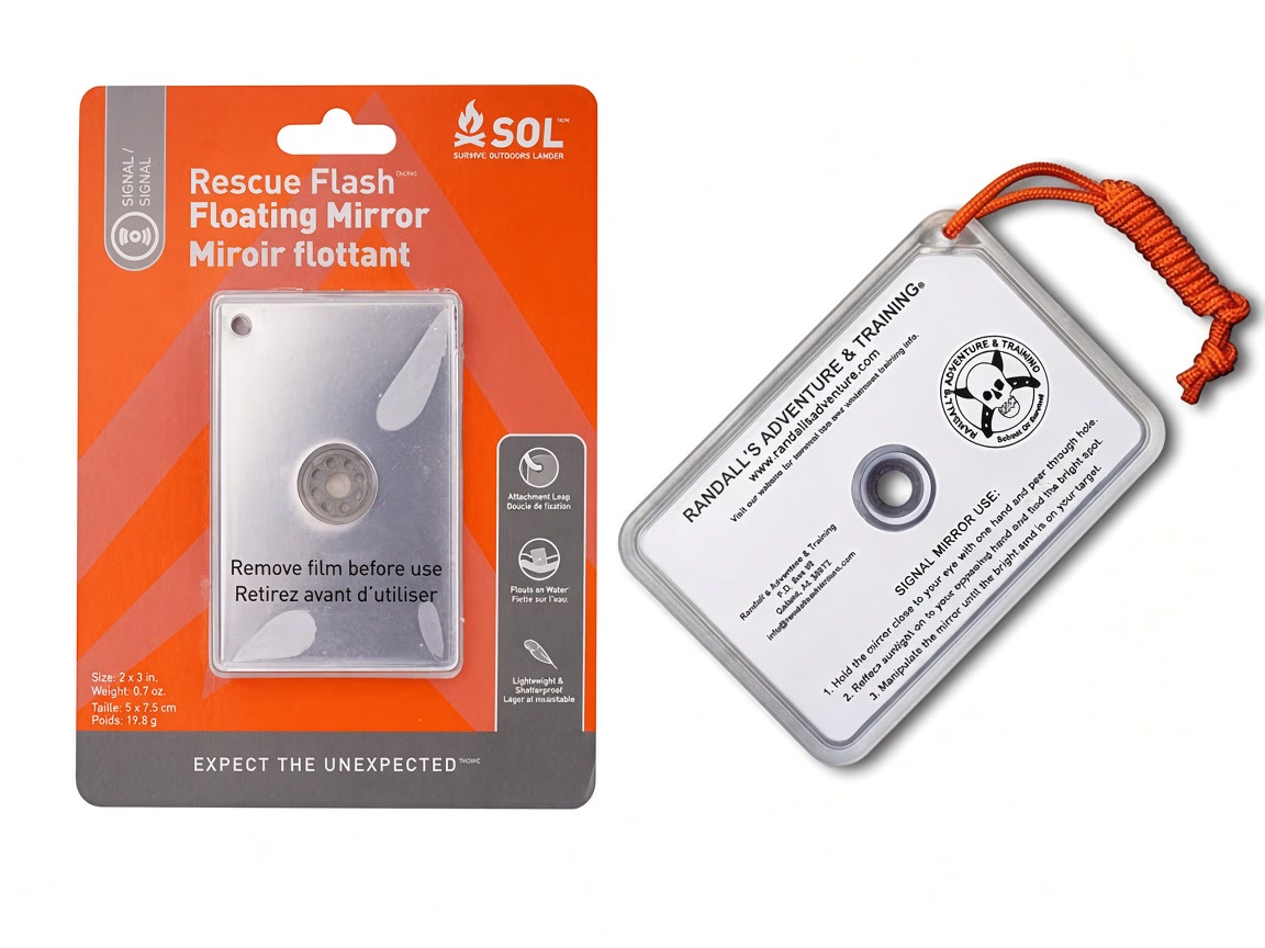 An SOL floating signal mirror in its card beside a clear signal mirror with an orange lanyard