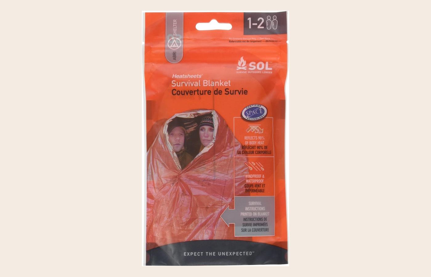 Adventure Medical SOL survival blanket in an orange pouch.