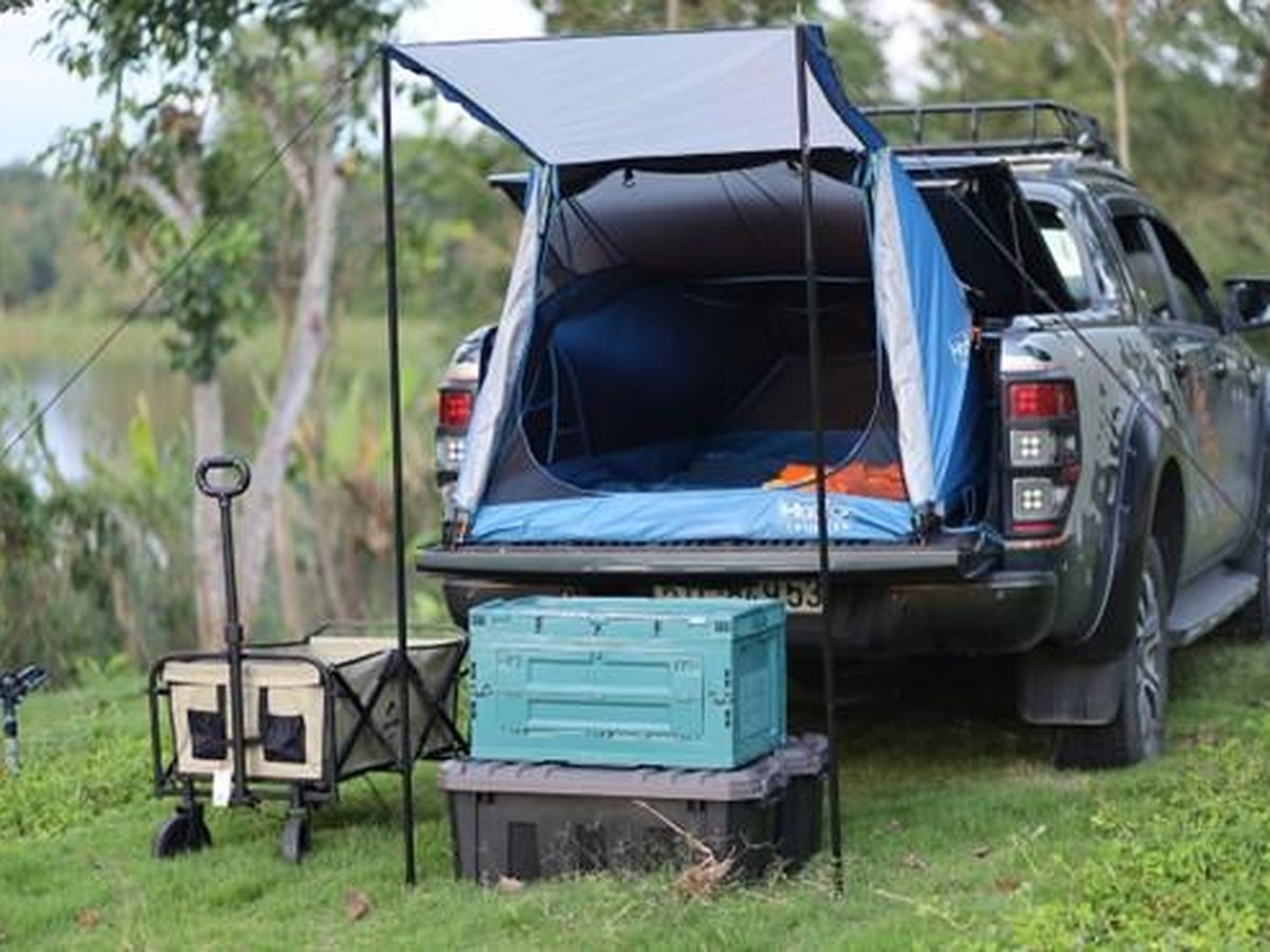 A truck-bed tent on a pickup, rainfly already on. Bed length is the first number.
