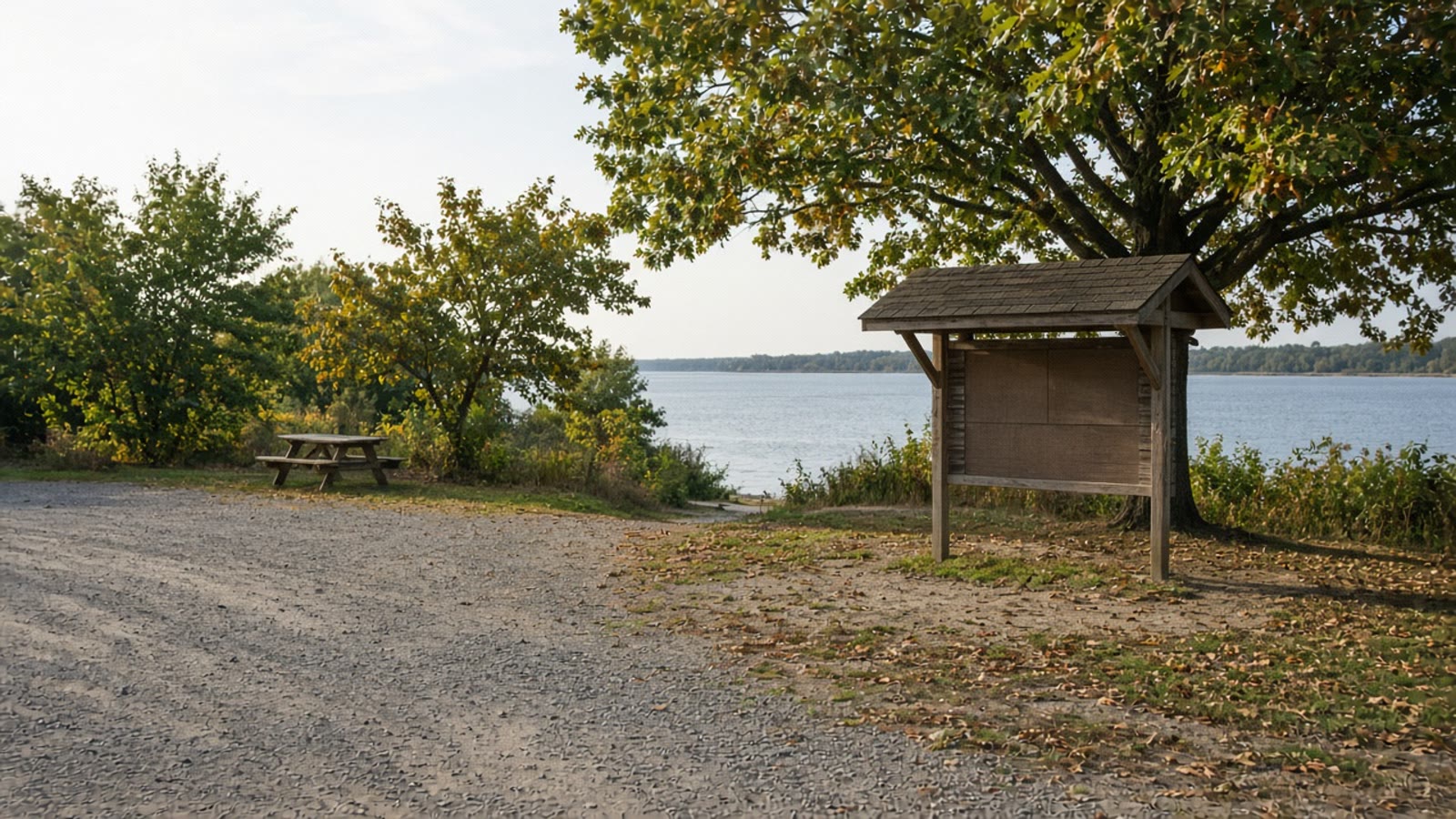 A quiet weekday state park trail after Labor Day with an empty picnic table in September light